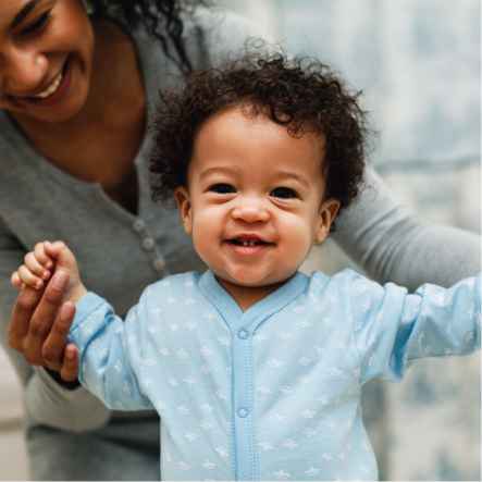 baby with mother smiling